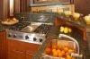 Transitional kitchen design with warm cabinetry