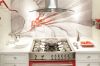 Oven and range surrounded by traditional white cabinetry