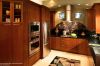 Contemporary kitchen with warm colored cabinets